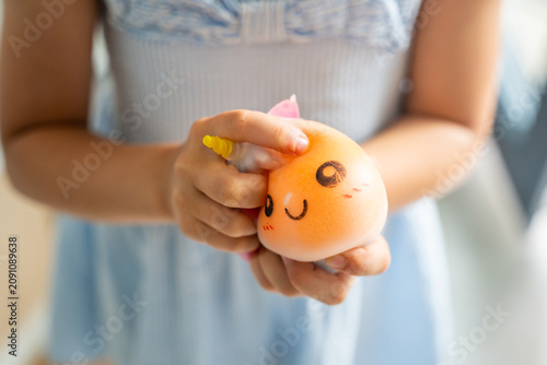 Foto Hands squeeze a soft squishy stress relief toy during sensory play