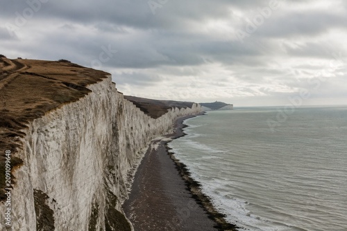 Dover white cliffs and expansive coastline, overcast weather, cinematic landscape.