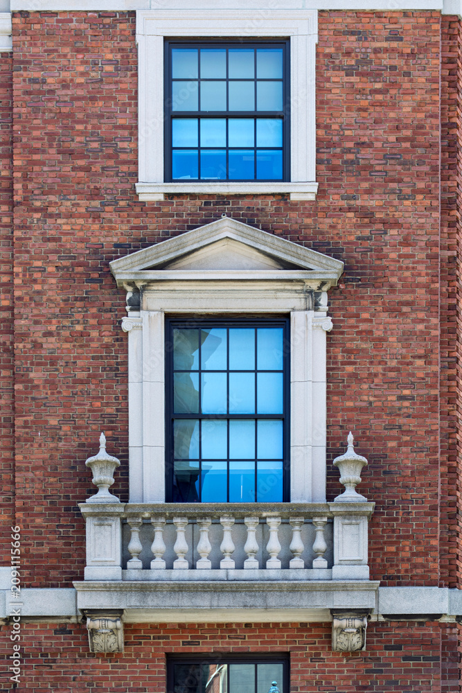 Fototapeta premium Classic Georgian architecture featuring a white multi-pane window on a red brick building at Harvard University in Cambridge Massachusetts