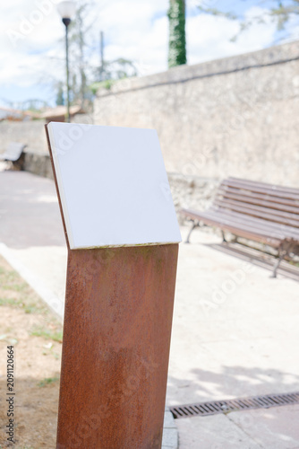 Blank information sign on rustic metal stand