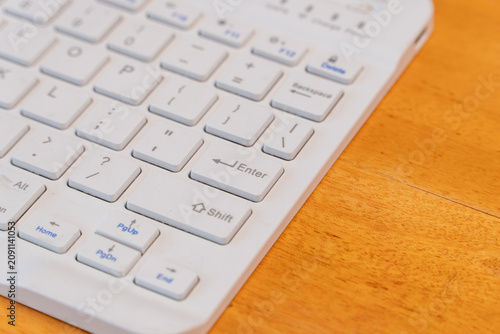 White computer keyboard with focus on Enter button