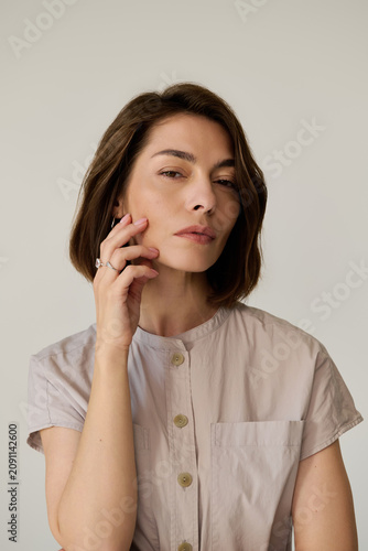 Canvas-taulu Chic woman showcasing elegance and style in minimalistic attire with graceful po