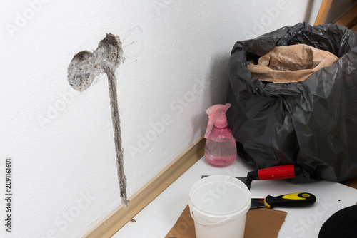 Fotografie Electrical rough-in work is underway on a white apartment wall