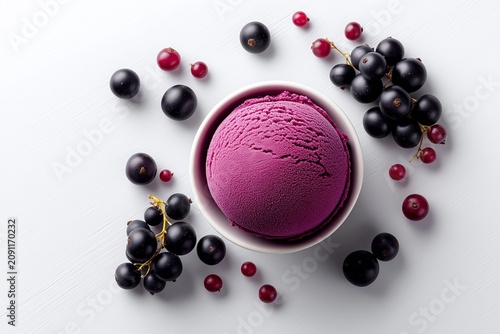 Blackcurrant Ice Cream Scoop in Bowl with Fresh Blackcurrants and Redcurrants.