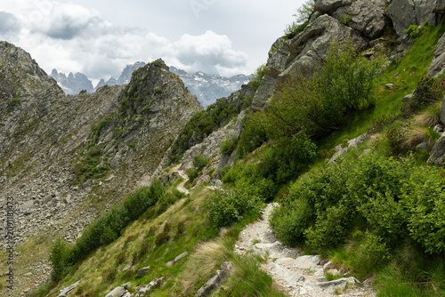 Mountain hiking trail through rocky alpine landscape in the Brenta Dolomites, Italy