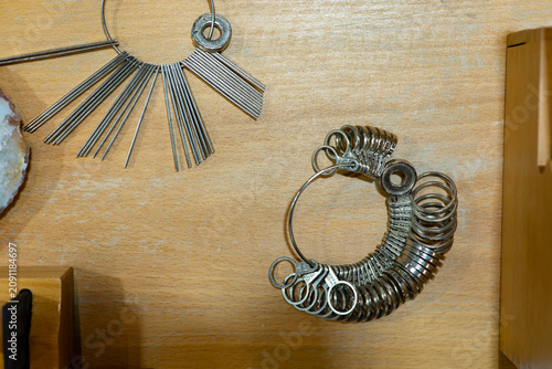 Jeweler Tools with Ring Sizer Gauge and Wire Measuring Gauge on Wooden Workbench