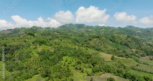 Tropical mountain with green forests and agricultural land with farm plantations. Mindanao, Philippines.