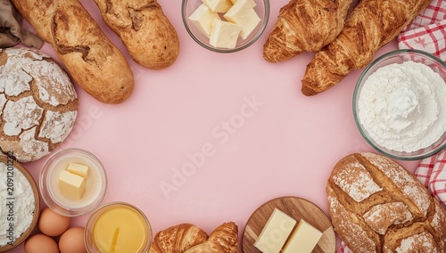 Bakery Items and Ingredients Arranged on a Pink Background for Cooking and Ba...