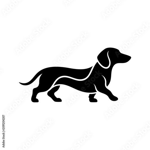 Konstfotografi A black silhouette of a dog runs quickly across a field.