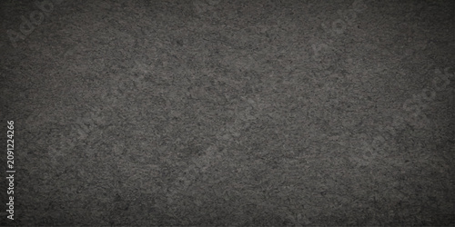 Картината върху платно A close-up shot reveals a rough, dark grey concrete texture, showcasing the granular surface and subtle variations in tone that evoke a sense of industrial strength and raw material