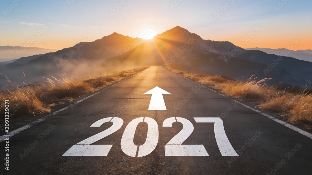 Obraz premium White number 2027 painted on an asphalt road leading toward a bright sun rising behind majestic mountain peaks in a scenic landscape during the early morning
