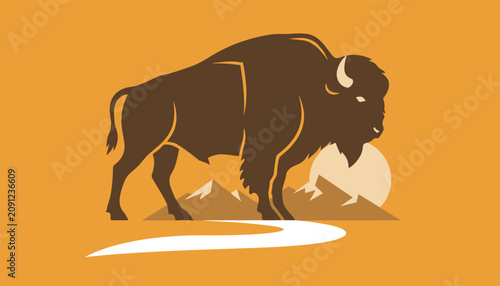 Majestic american bison silhouette standing against mountain landscape and sun on orange background.