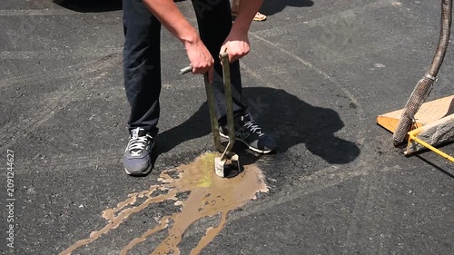 Extraction of an asphalt core sample after fresh paving of the road surface to check the quality of the new asphalt