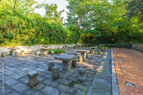 A seating area with stone pillars and bollards in a park in China