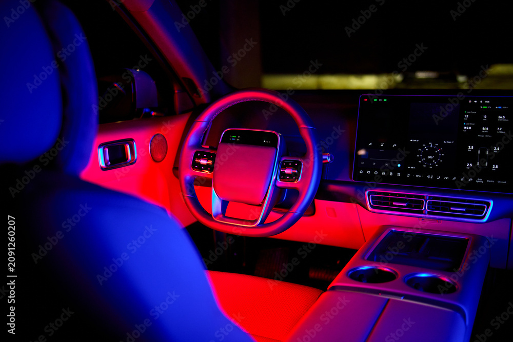 Fototapeta premium luxurious car interior stationary in parking lot with leather and plastic materials, modern and serene perspective from driver's seat, black and gray tones, automotive design and luxury.