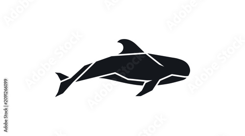 Silhouette of an orca whale swimming in ocean water
