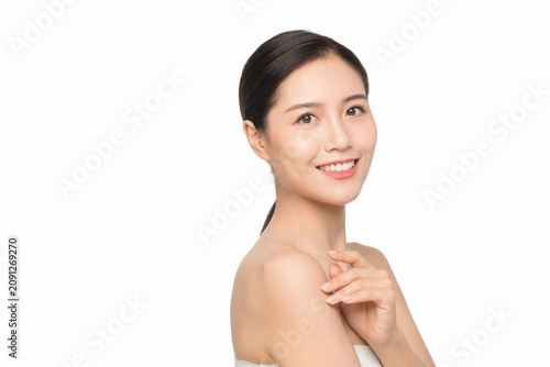 Smiling young woman with healthy skin and bare shoulder