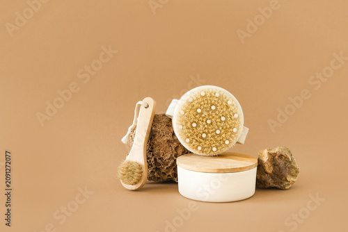 Set of natural wood brushes and spa accessories for body exfoliation and facial cleansing, beige background. Organic spa care, eco-beauty concept