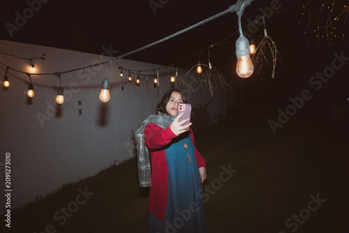 Candid UGC Night Snapshot of Woman Taking Selfie in Backyard