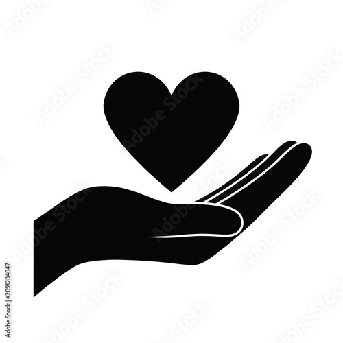 Silhouette of hand holding heart symbol.