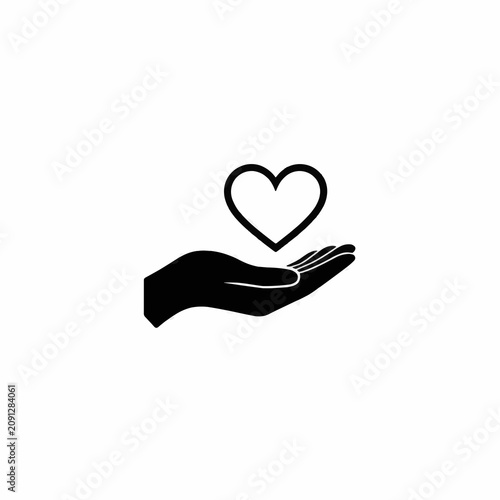 Silhouette of hand holding heart symbol.