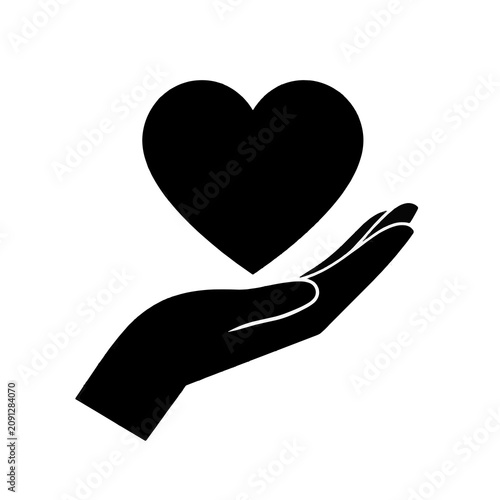 Silhouette of hand holding heart symbol.