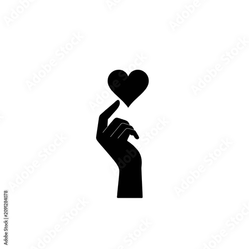 Silhouette of hand holding heart symbol.
