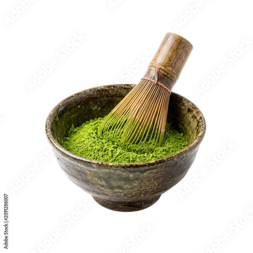 Fresh green matcha powder in a wooden bowl with bamboo whisk