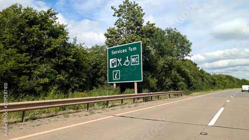Fotografía Services roadside sign on highway, green traffic information board with petrol s