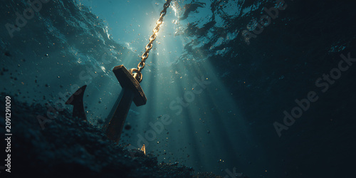 An anchor on the seabed with light rays filtering through the water
