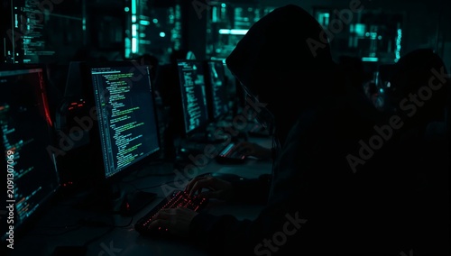 People Working on Computers in a Dark Room During a Programming Session