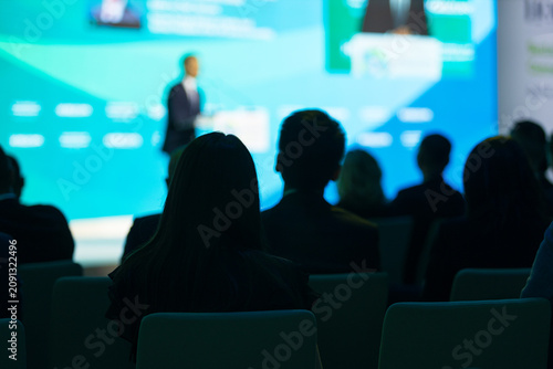 Принти на полотні Public speaker addressing attentive audience during corporate presentation or business conference