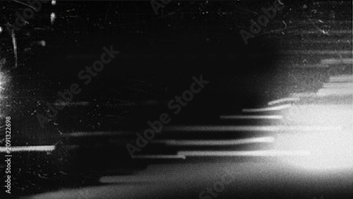 Black and white abstract background with light streaks and grainy texture overlay effect.