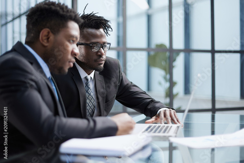 African american boss negotiating discussing contract details with company corporate client.