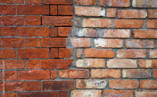 Two different types and shades of red brick walls fusing into each other in the middle of the photo. Beautiful unique architectural detail photographed in Dublin, Ireland.
