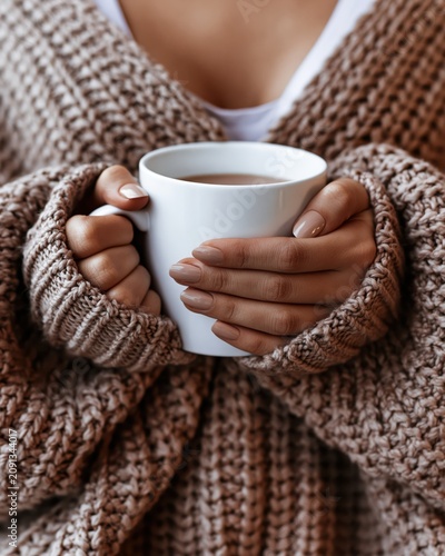 Woman Hands Holding Warm Mug In Cozy Oversized Knit Sweater