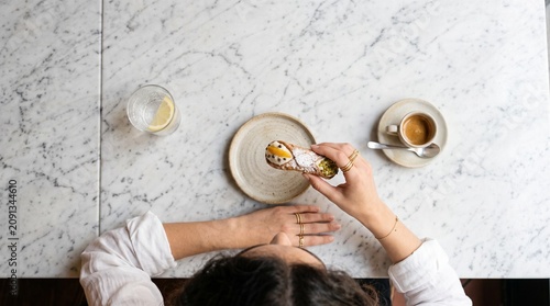 Commercial medium close-up lifestyle photography of a freshly made traditional Italian cannoli dessert – premium bakery branding, gourmet pastry marketing