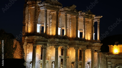 Night view of the historic Ephesus Ancient City in Turkey, showcasing illuminated Roman ruins and timeless classical architecture after sunset.