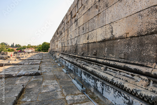 Fotografie Ancient stone wall at architectural ruins with clear blue sky