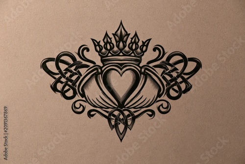 Ink drawing of a Claddagh tattoo featuring heart, hands, and crown with Celtic patterns