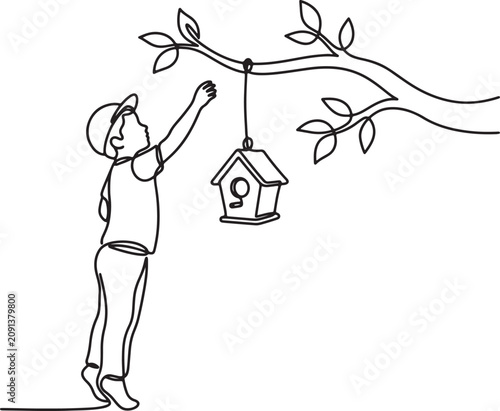 Obraz na płótnie man hanging birdhouse on tree branch outdoors