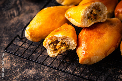 Obraz na plátně Traditional baked pies pirozhki with meat.