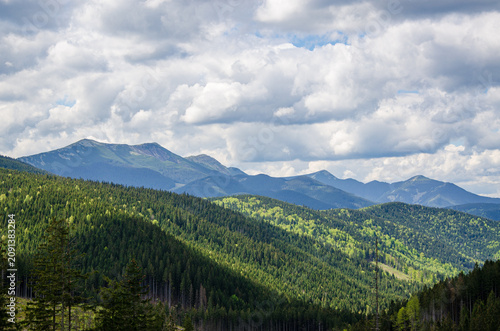 Scenic view of Carpathian mountain ridge under dramatic cloudy sky. Gorgany mountains