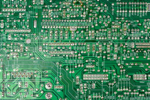 Close-up of electronic pathways and soldering points. Detailed information on printed circuit board technology. Copper traces on the substrate,