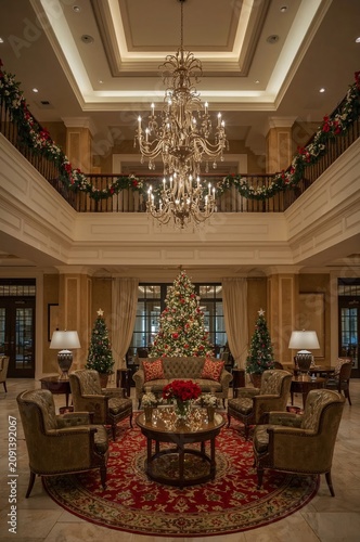 Christmas Decoration in a Hotel Lobby With Trees and a Chandelier at Night