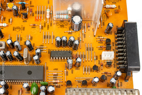 Brown printed circuit board components and parts. electronic circuit board containing radio components from an electronic device.