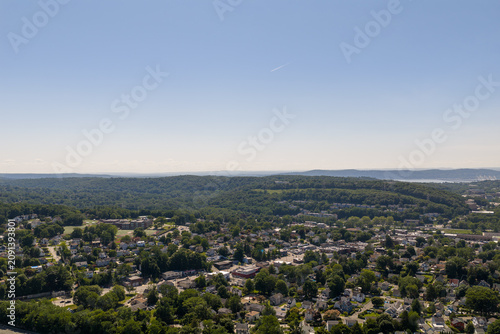 фотографія Aerial view town houses green hills summer landscape