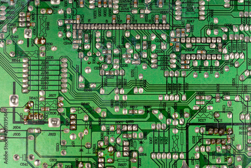 Close-up of electronic pathways and soldering points. Detailed information on printed circuit board technology. Copper traces on the substrate,