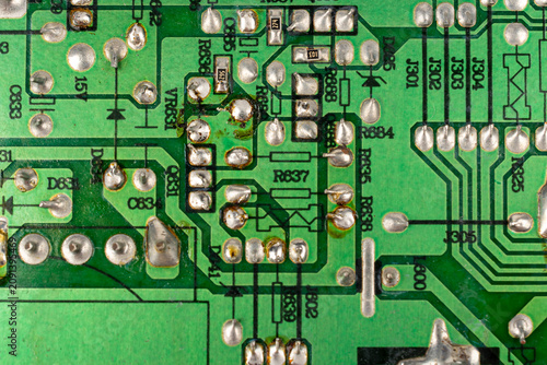 Close-up of electronic pathways and soldering points. Detailed information on printed circuit board technology. Copper traces on the substrate,