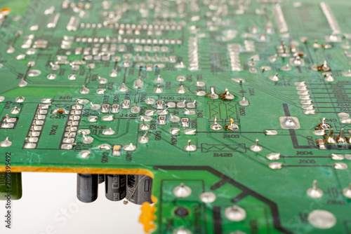 Close-up of electronic pathways and soldering points. Detailed information on printed circuit board technology. Copper traces on the substrate,